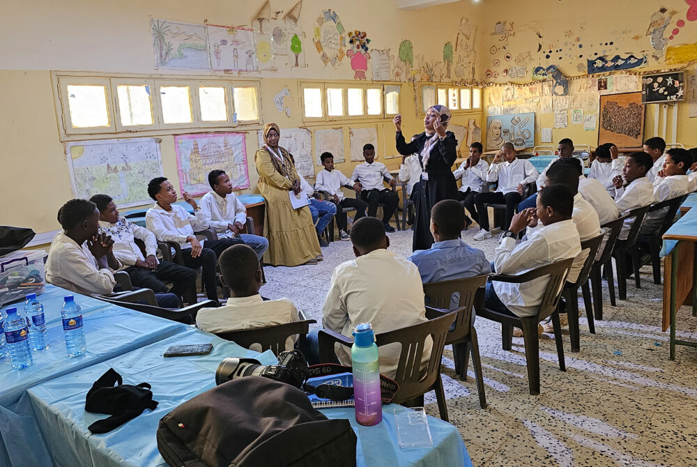 12 November 2023 (GHAT) Libya. Dr. Halima Ramadan, in the middle, engaging with adolescents in Ghat who are actively participate in a Life Skills program session, forging a path of learning, growth, and community. Photo: Abdullah Hussein/ UNICEF Libya