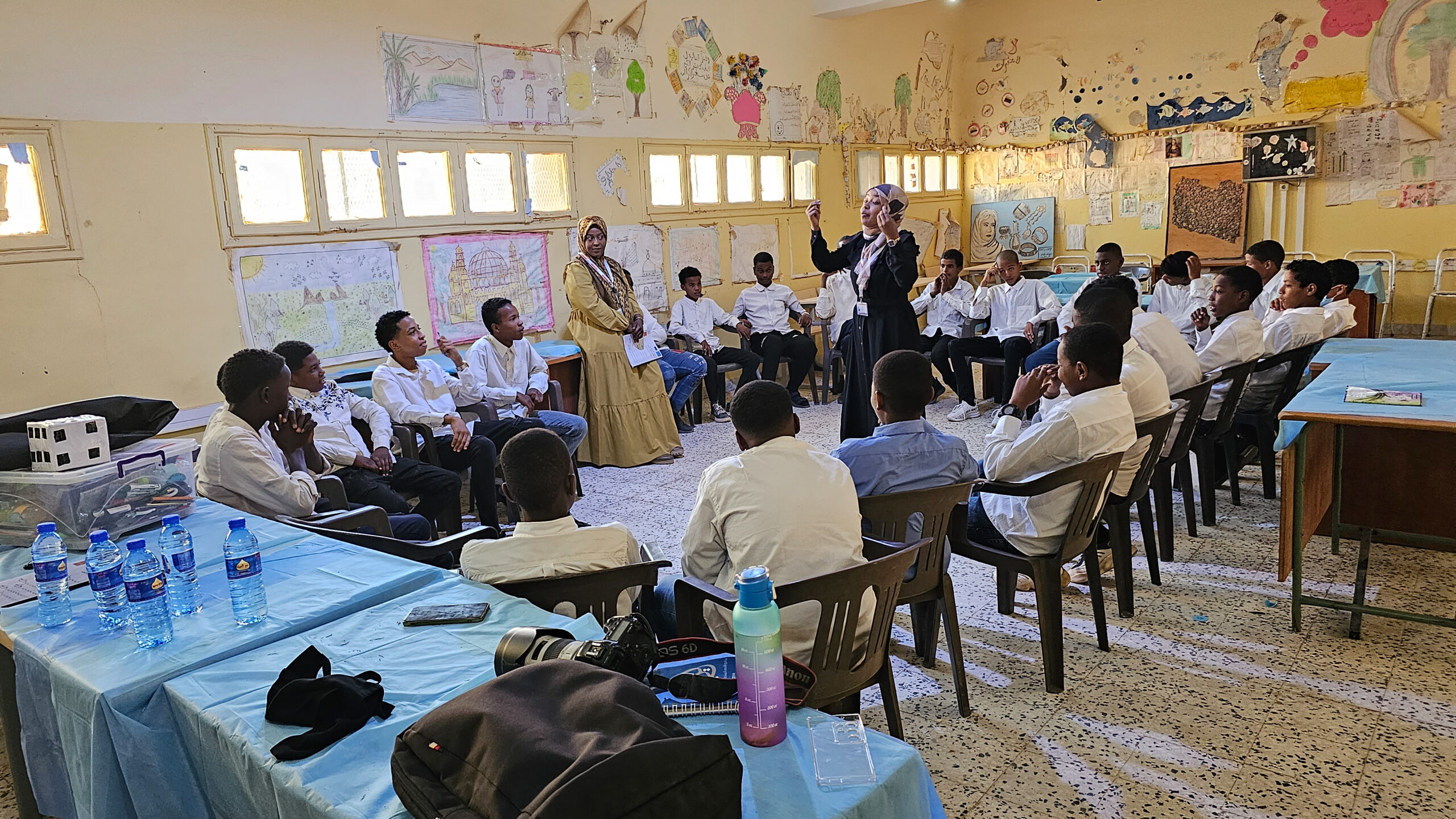 12 November 2023 (GHAT) Libya. Dr. Halima Ramadan, in the middle, engaging with adolescents in Ghat who are actively participate in a Life Skills program session, forging a path of learning, growth, and community. Photo: Abdullah Hussein/ UNICEF Libya